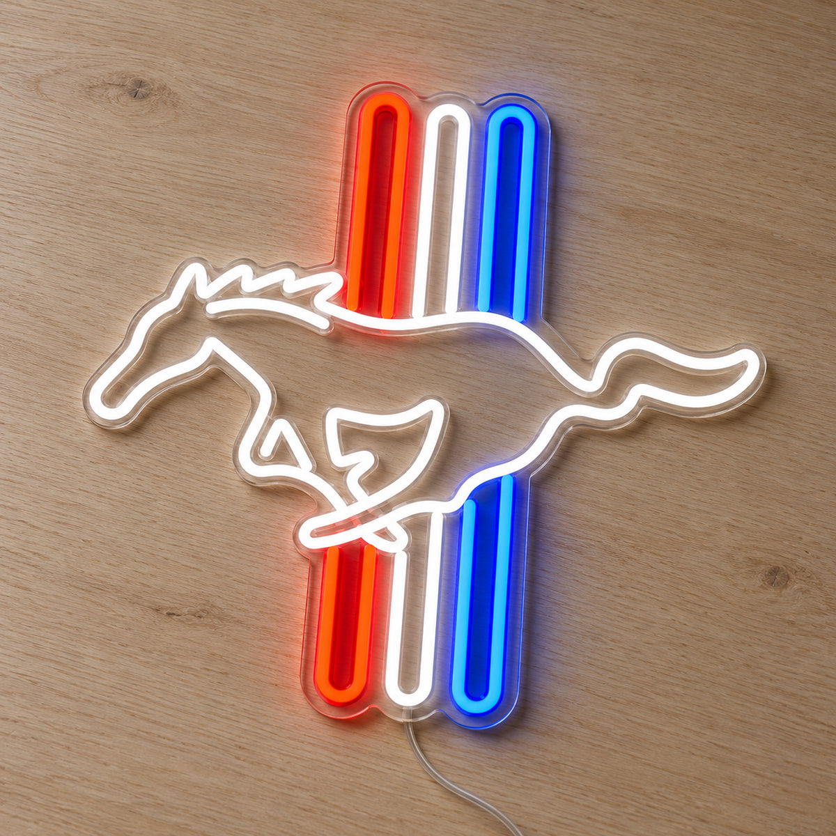 Ford Mustang Tri-Bar LED Neon Sign in red, white and blue, featuring a Mustang horse outline over three vertical stripes on a wooden surface.