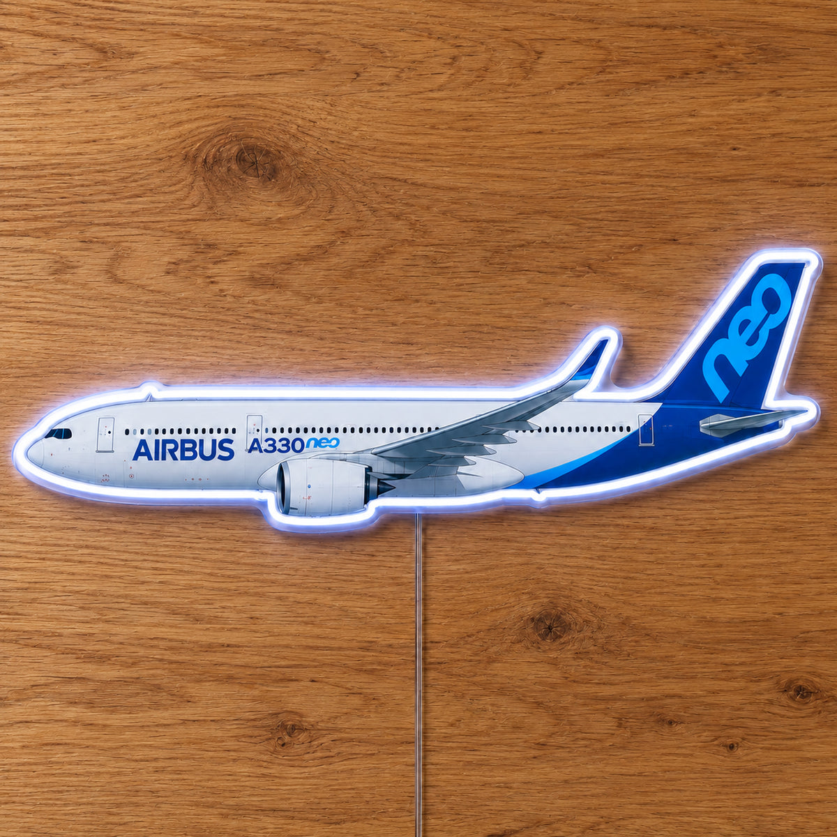 Airbus A330neo Neon Sign with printed aircraft details and an illuminated LED outline on clear acrylic, shown on a wooden surface