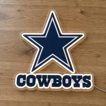 Dallas Cowboys LED neon sign featuring the team's star logo and 'COWBOYS' text, illuminated on a wooden surface.