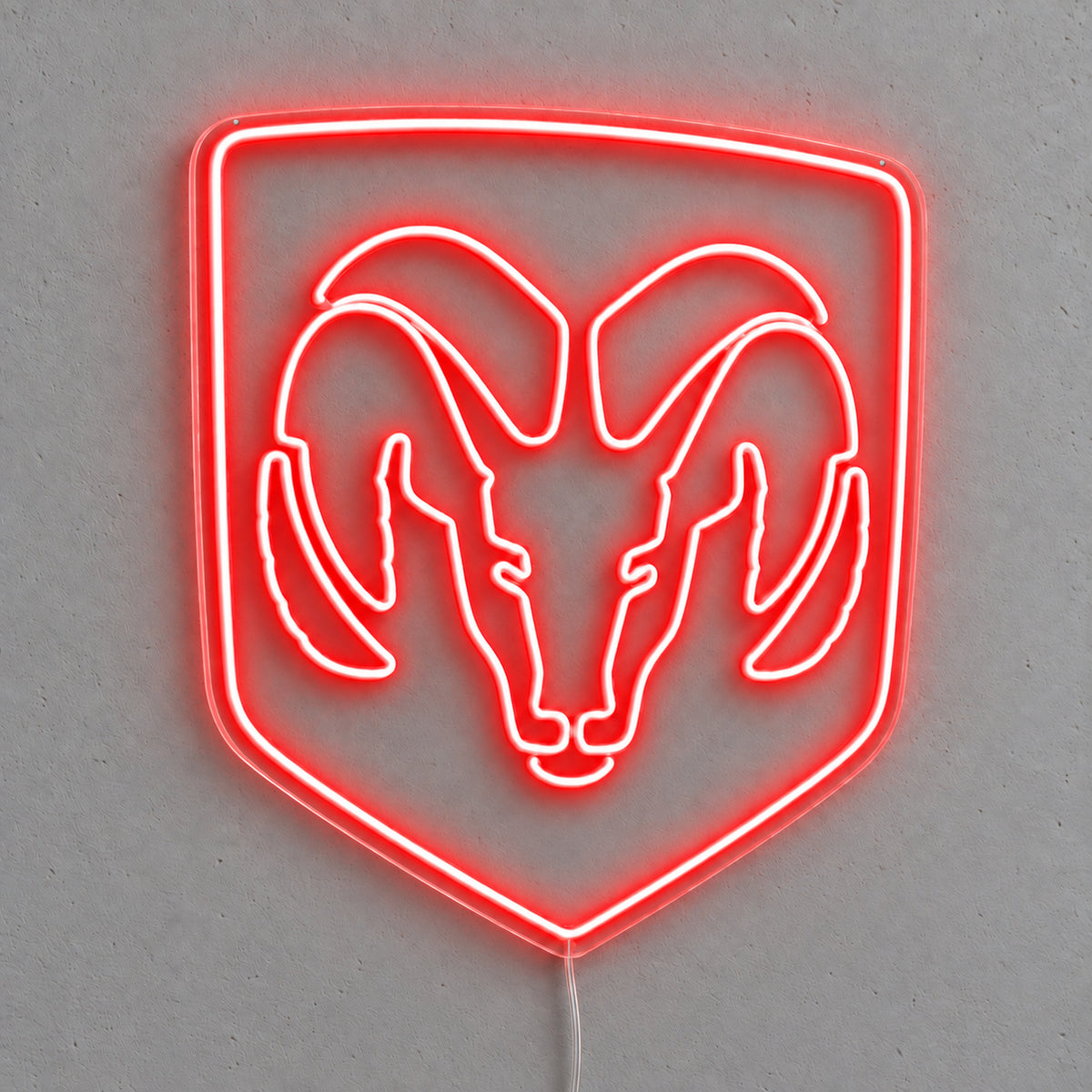 Dodge Ram Logo LED Neon Sign in red, featuring a Ram head inside a shield outline on a grey wall.
