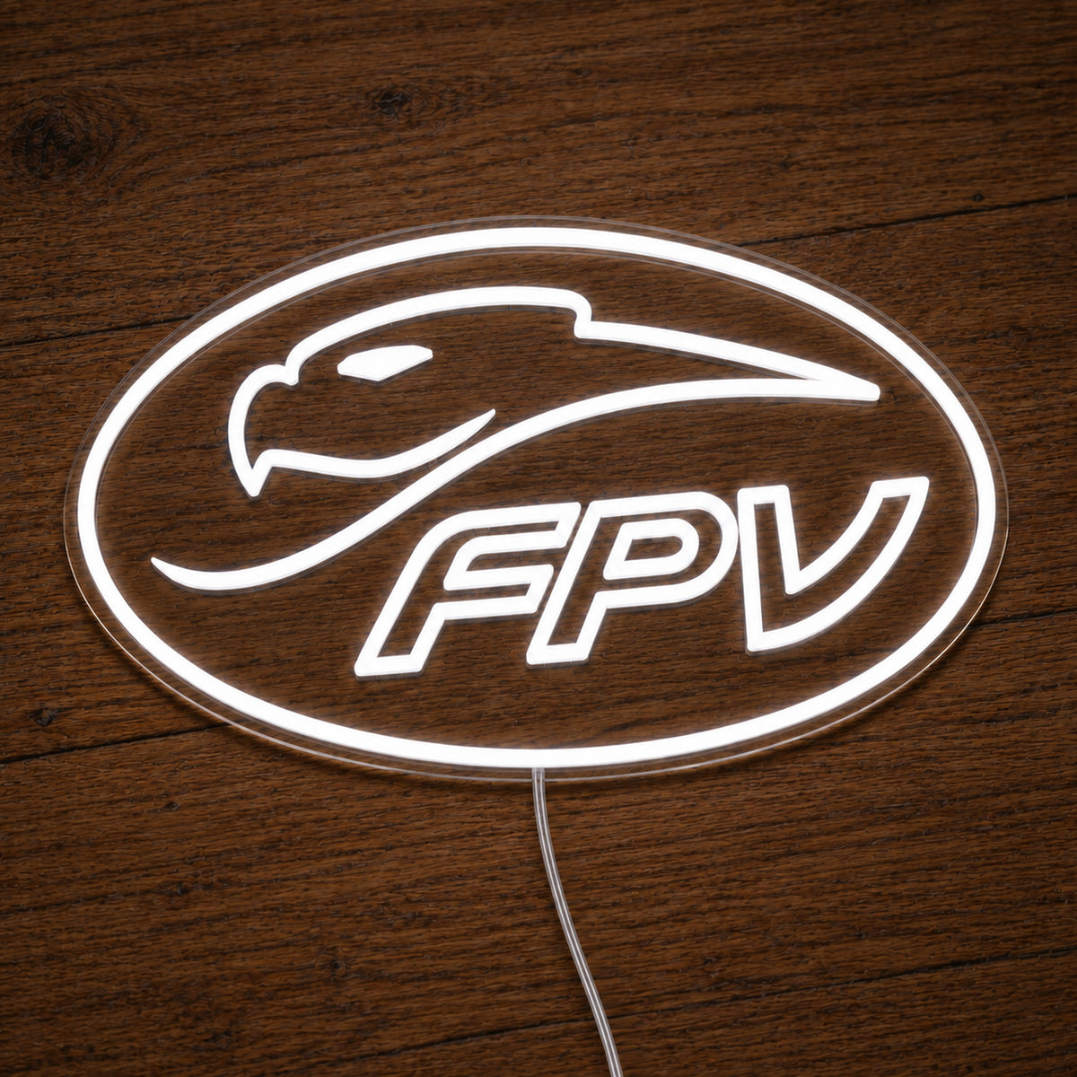 FPV Ford Performance Vehicles LED Neon Sign in warm white, featuring oval FPV logo with a bird-head outline on a wooden surface.