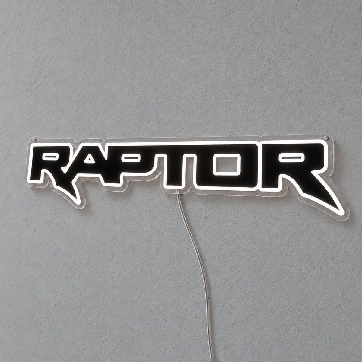 Ford Ranger Raptor LED Neon Sign in white, featuring outlined Raptor lettering on a grey wall.