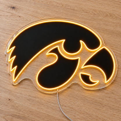 Iowa Hawkeyes LED Neon Sign, featuring team logo displayed on a wooden surface.