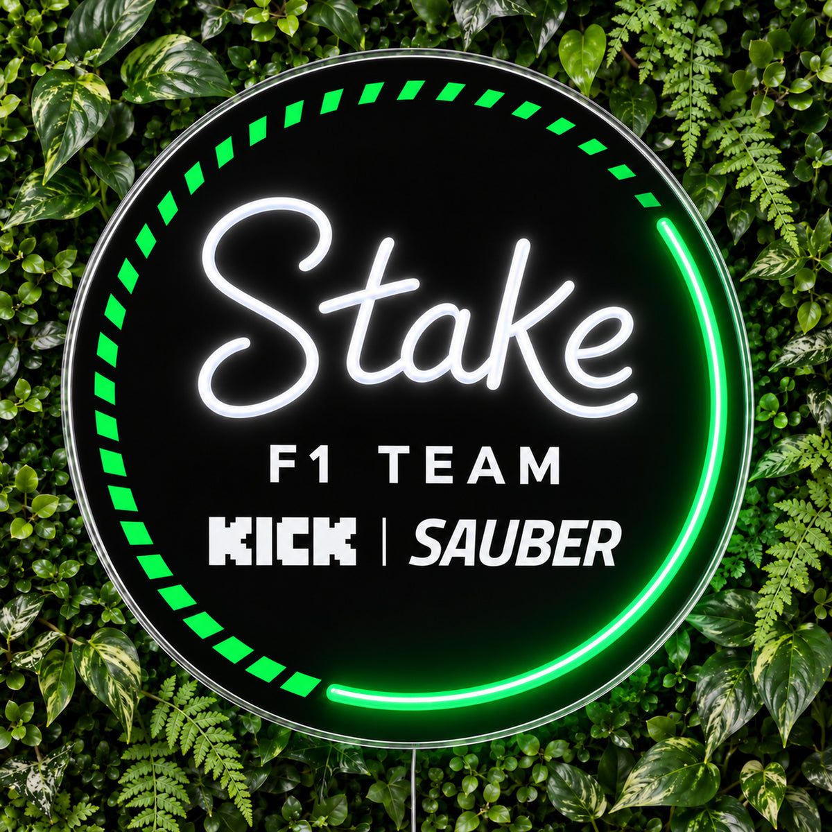 Kick Sauber F1 LED Neon Sign, featuring team logo displayed on a green foliage wall.