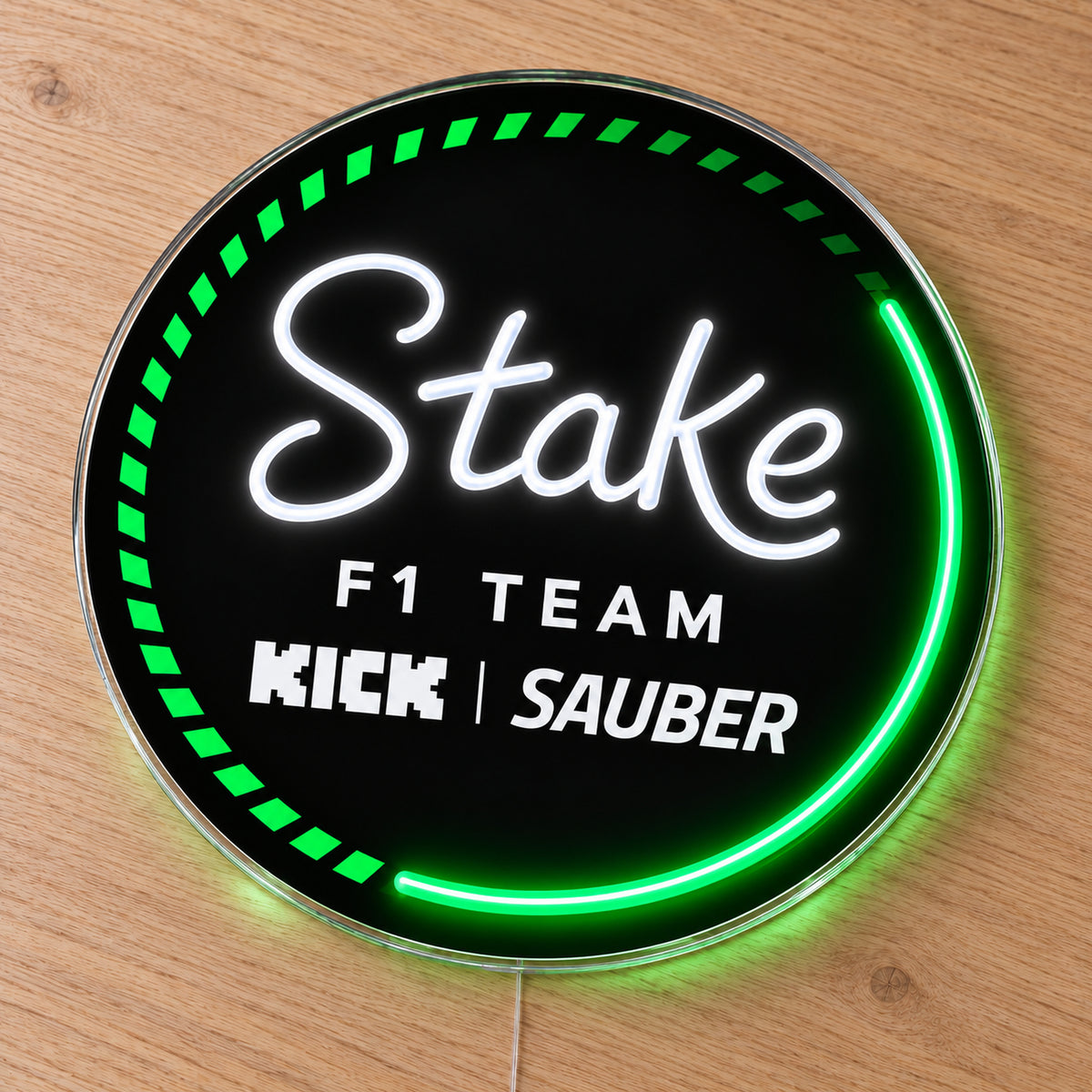 Kick Sauber F1 LED Neon Sign, featuring team logo displayed on a wooden surface.