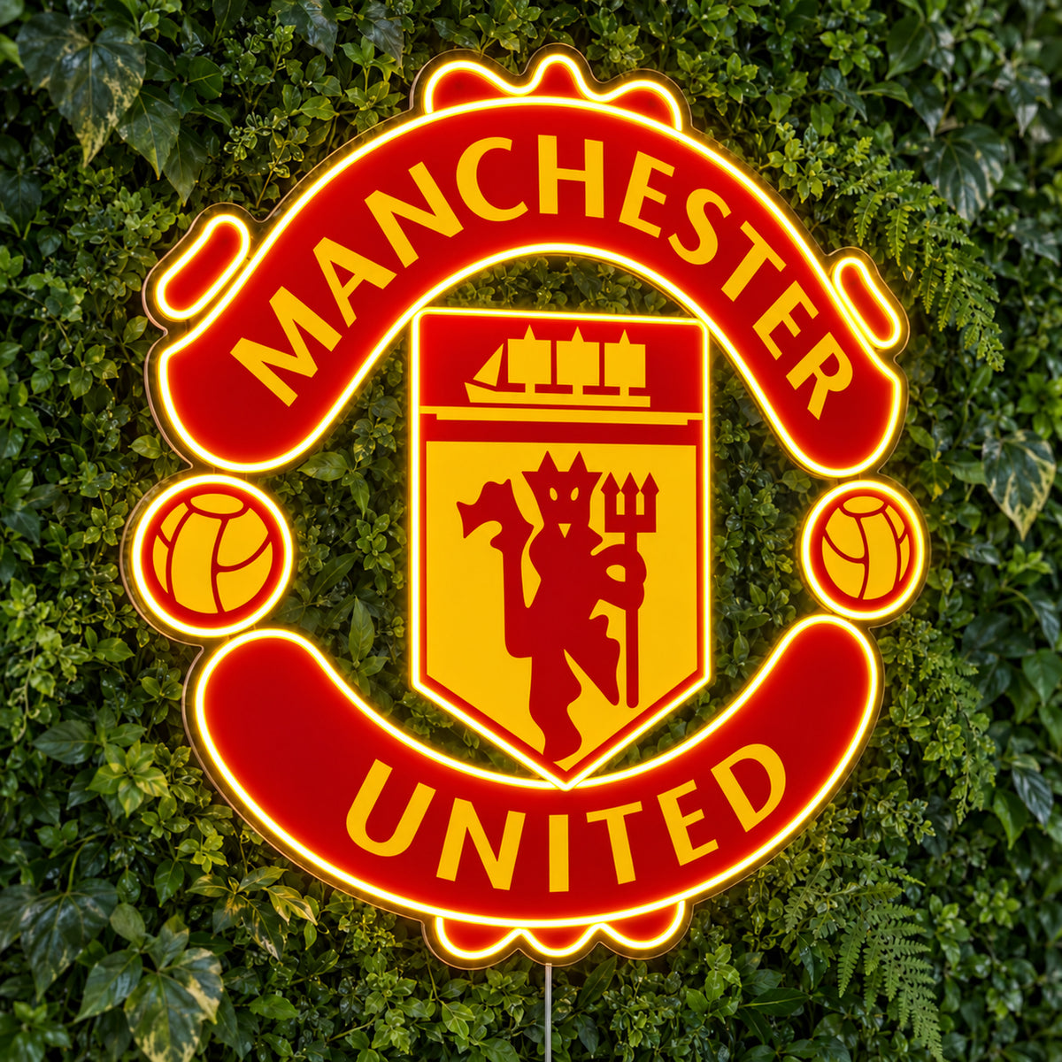 Manchester United LED Neon Sign, featuring team logo displayed on a green foliage wall.