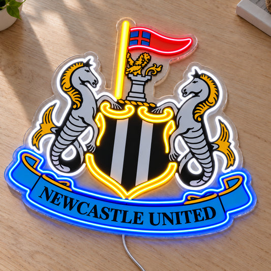 Newcastle United LED Neon Sign, featuring team logo displayed on a wooden surface.
