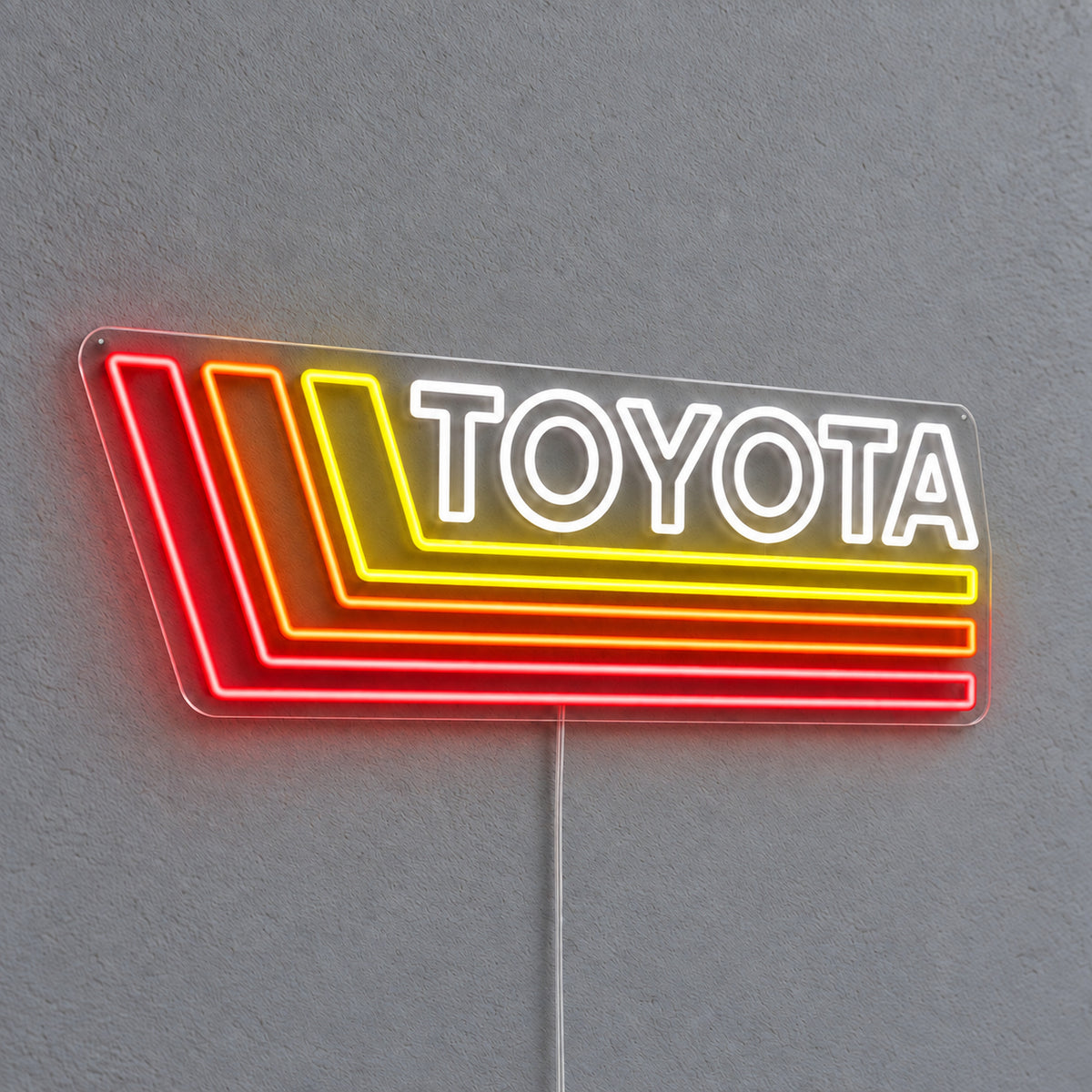 Toyota Retro Land Cruiser LED Neon Sign in white, red and yellow, featuring Toyota lettering with retro stripes on a grey wall.