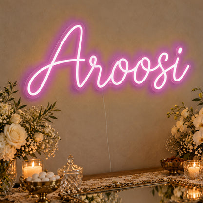 Aroosi Neon Sign in pink LED neon on clear acrylic, angled view