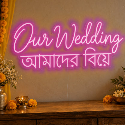 Our Wedding English & Bengali Neon Sign in pink LED neon on clear acrylic, angled view