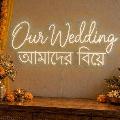 Our Wedding English & Bengali Neon Sign in warm white LED neon on clear acrylic, angled view