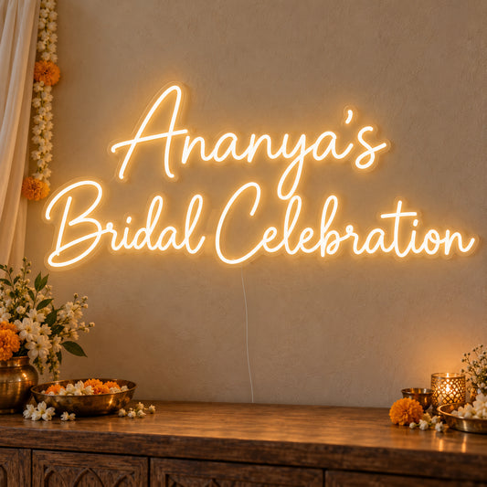 Personalised Bridal Celebration Neon Sign on clear cut-to-shape acrylic, illuminated on a wall in a styled celebration setting; sample personalised wording shown