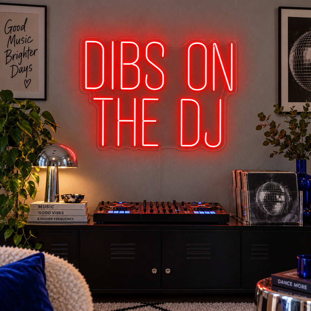 Dibs On The DJ Neon Sign with red lighting, displayed above a home DJ setup.