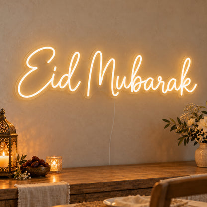 Eid Mubarak Neon Sign on clear cut-to-shape acrylic, illuminated on a wall in a styled celebration setting