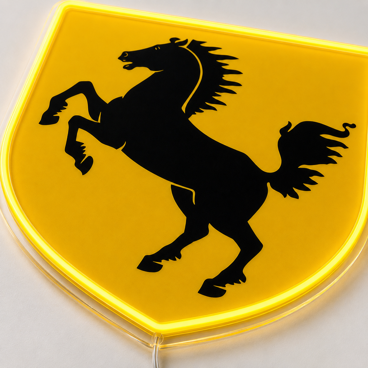 Close-up detail of Ferrari shield neon sign showing prancing horse and backlit acrylic edge