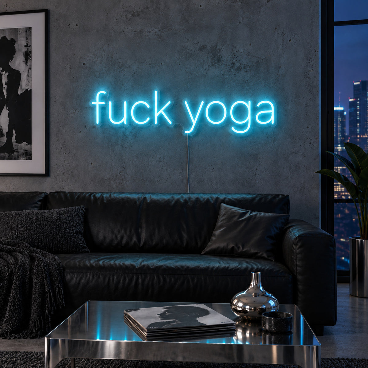 Ice Blue version of the Fuck Yoga Neon Sign, shown above a black leather sofa.