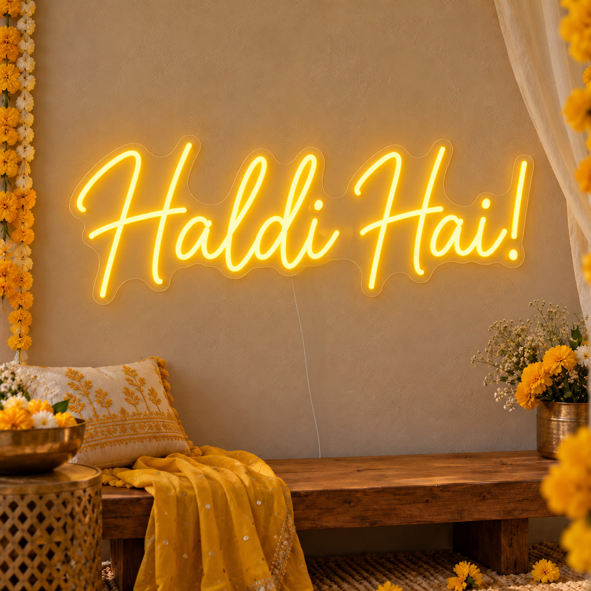 Haldi Hai Neon Sign on clear cut-to-shape acrylic, illuminated on a wall in a styled celebration setting