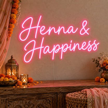 Henna Happiness Neon Sign on clear cut-to-shape acrylic, illuminated on a wall in a styled celebration setting