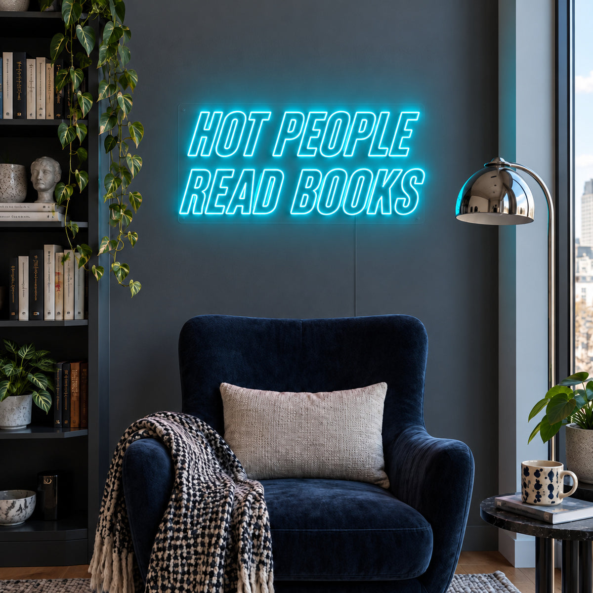 Ice Blue version of the Hot People Read Books Neon Sign, shown above a blue reading chair.