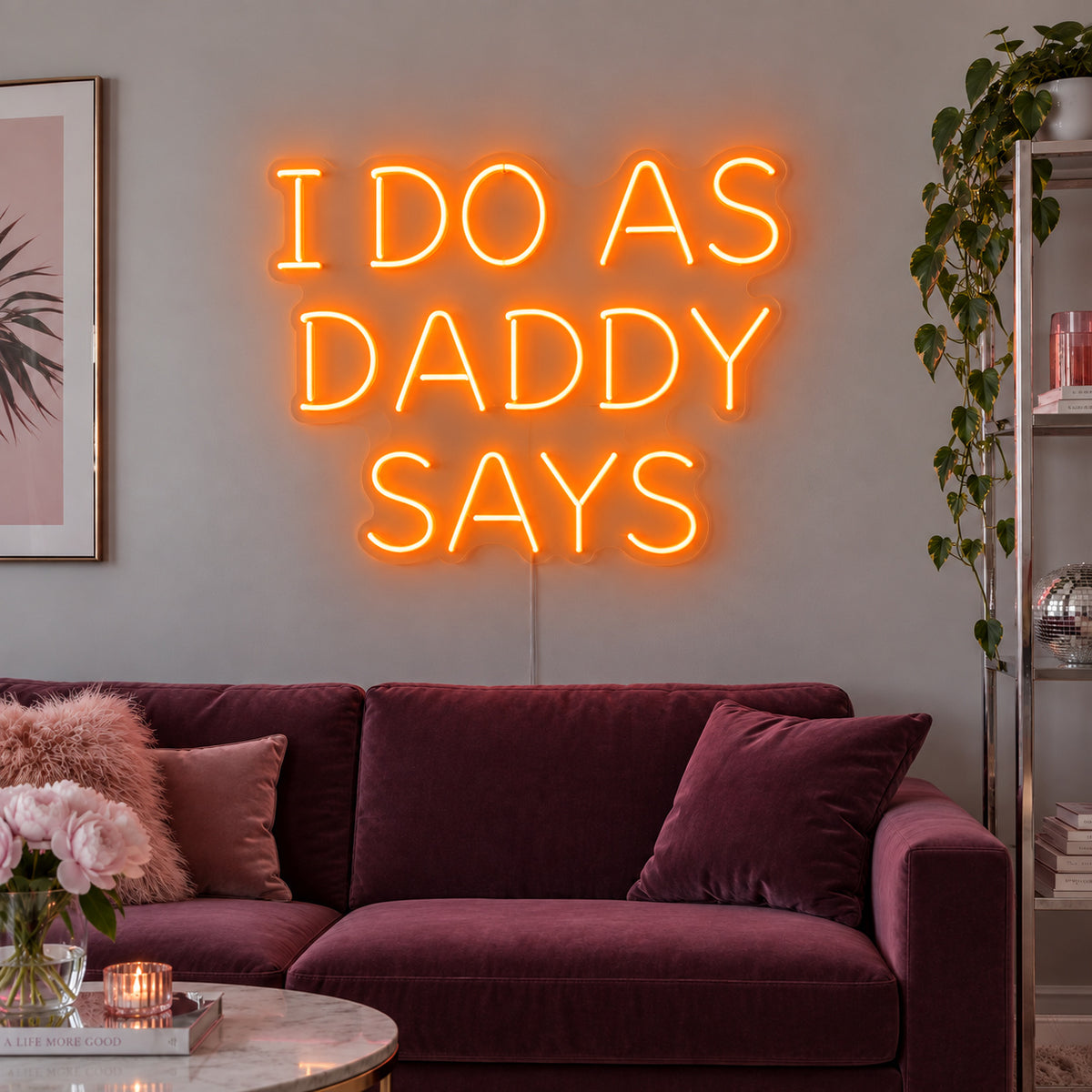 Orange version of the I Do As Daddy Says Neon Sign, shown above a burgundy sofa.