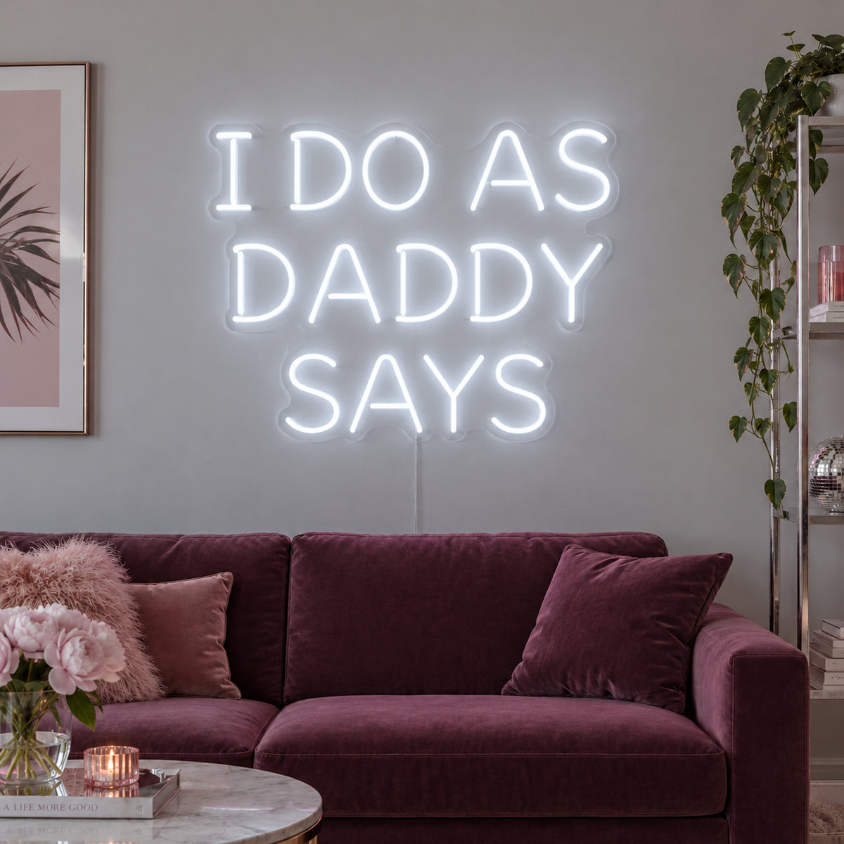 I Do As Daddy Says Neon Sign, RGB colour-changing option shown in white above a burgundy sofa.