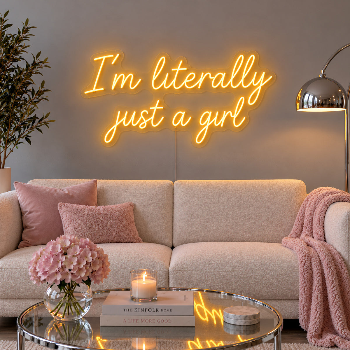I'm Literally Just A Girl Neon Sign glowing gold above a cream sofa.
