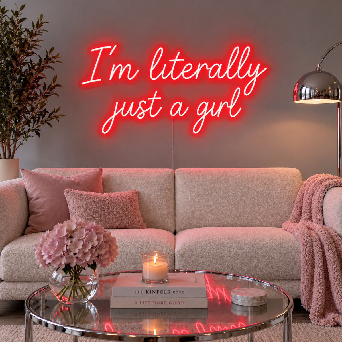 I'm Literally Just A Girl Neon Sign with red lighting, displayed above a cream sofa.