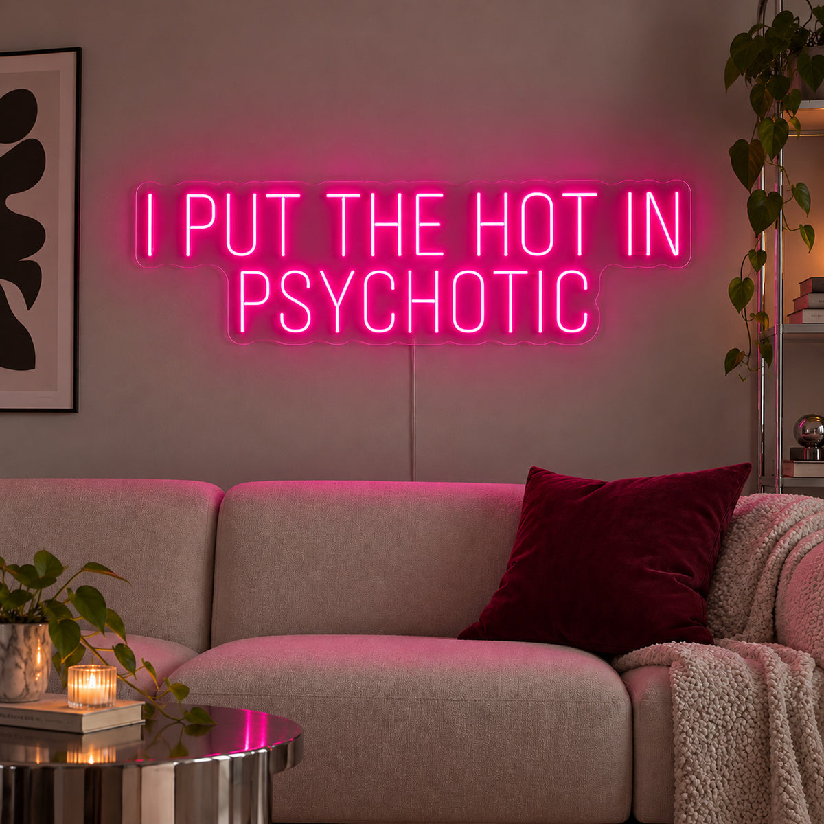 Rose Red version of the I Put The Hot In Psychotic Neon Sign, shown above a neutral sofa.