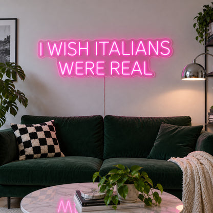 Rose Red version of the I Wish Italians Were Real Neon Sign, shown above a green sofa.