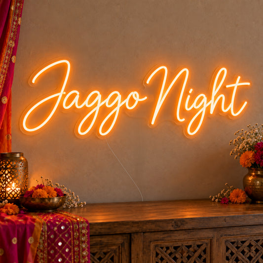 Jaggo Night Neon Sign on clear cut-to-shape acrylic, illuminated on a wall in a styled celebration setting