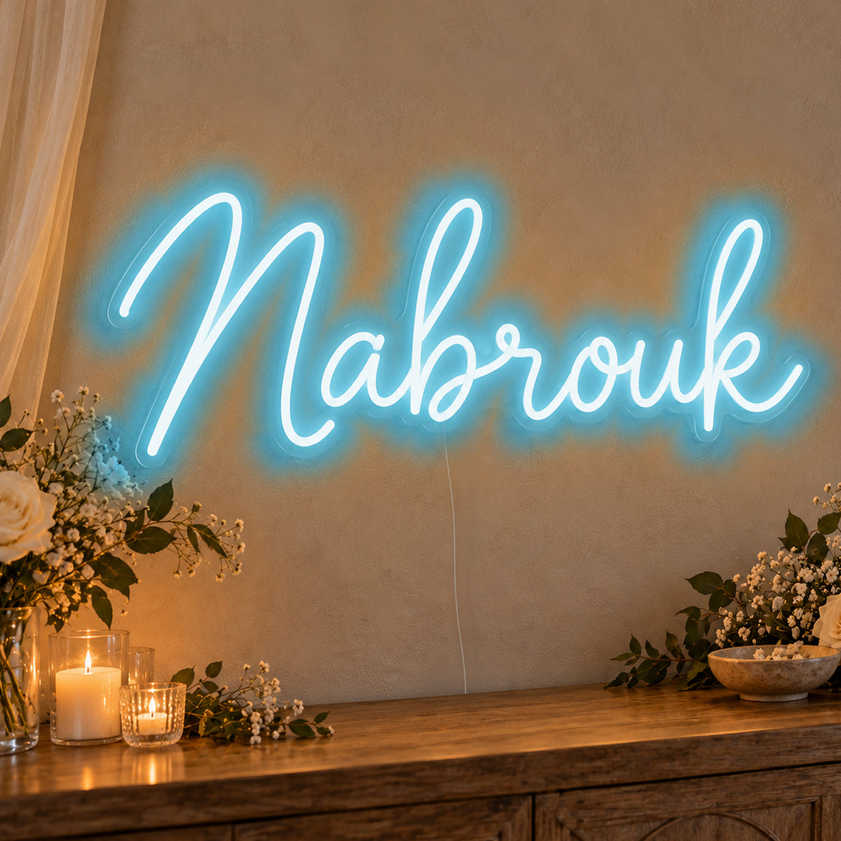 Mabrouk Neon Sign in ice blue LED neon on clear acrylic, angled view