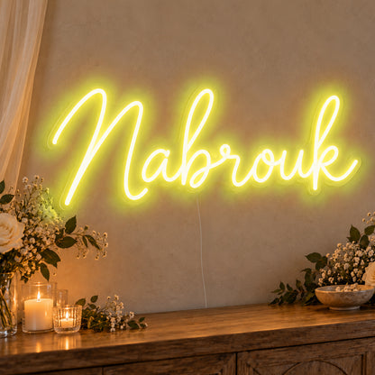 Mabrouk Neon Sign in yellow LED neon on clear acrylic, angled view