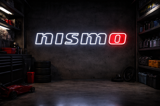 Nissan Nismo LED neon sign with white lettering and red O mounted on concrete garage wall