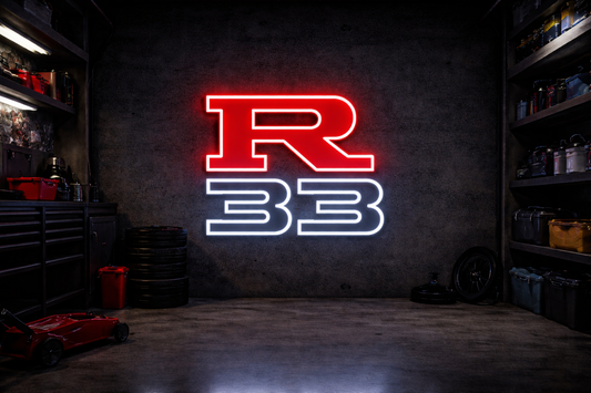Nissan R33 LED neon sign with red R and white 32 outline mounted on concrete garage wall