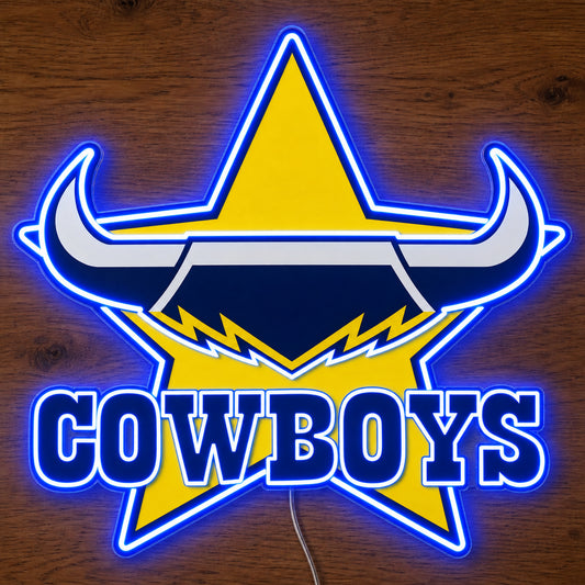 North Queensland Cowboys neon sign glowing brightly on a wooden surface in dim lighting