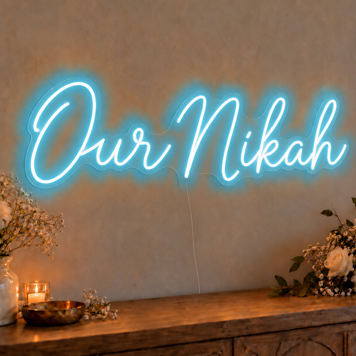 Our Nikah Neon Sign in ice blue LED neon on clear acrylic, angled view