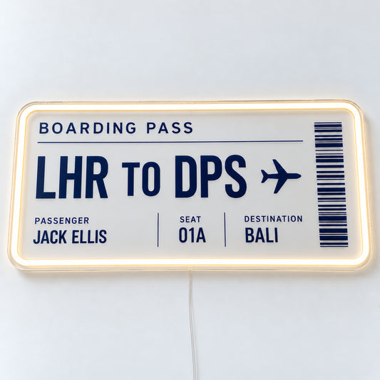 Personalised Boarding Pass Neon Sign, featuring a personalised boarding pass, shown with Jack Ellis and the LHR to DPS route, on a single clear acrylic backing displayed on a white surface.