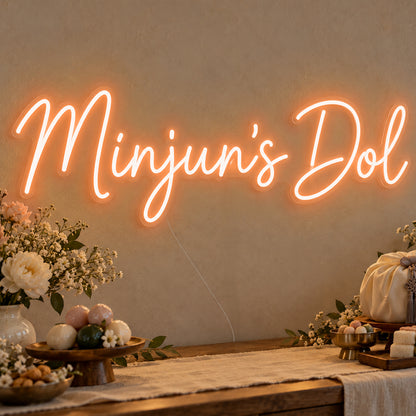 Personalised Dol Neon Sign in orange LED neon on clear acrylic, angled view