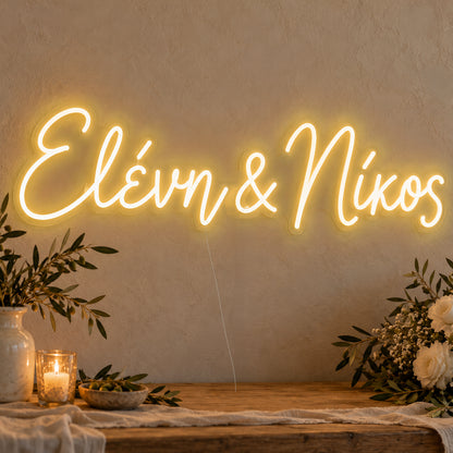 Personalised Greek Couple Names Neon Sign in gold LED neon on clear acrylic, angled view