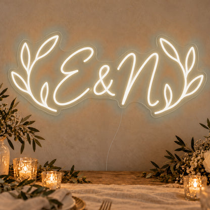 Personalised Olive Initials Neon Sign in warm white LED neon on clear acrylic, angled view