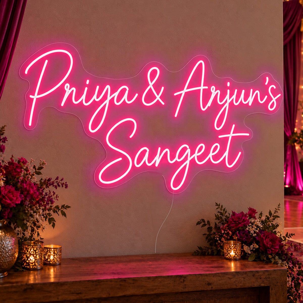 Personalised Sangeet Neon Sign in rose red LED neon on clear acrylic, angled view