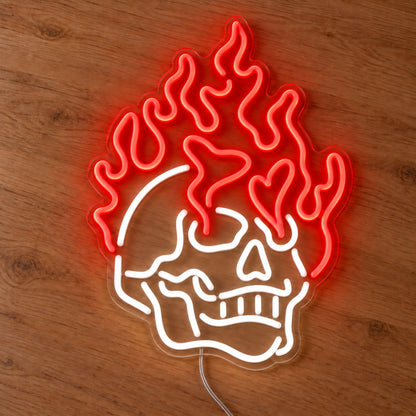 Red Flaming Skull Neon Sign with red flames and white skull on a clear acrylic backing, photographed on wood.