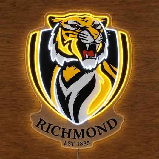 Richmond Tigers neon sign glowing brightly on a wooden surface in dim lighting