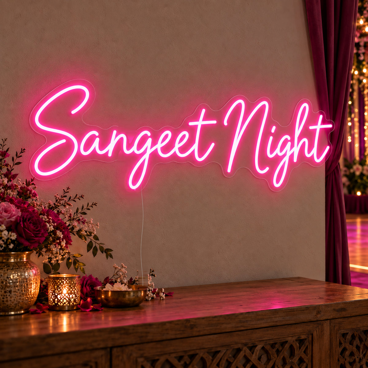 Sangeet Night Neon Sign on clear cut-to-shape acrylic, illuminated on a wall in a styled celebration setting