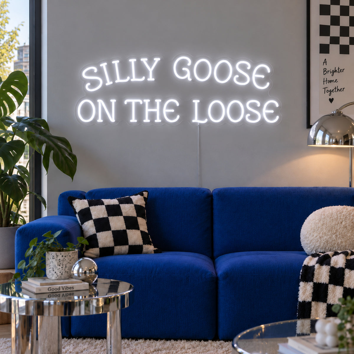 Silly Goose On The Loose Neon Sign, RGB colour-changing option shown in white above a blue sofa with checkered cushions.