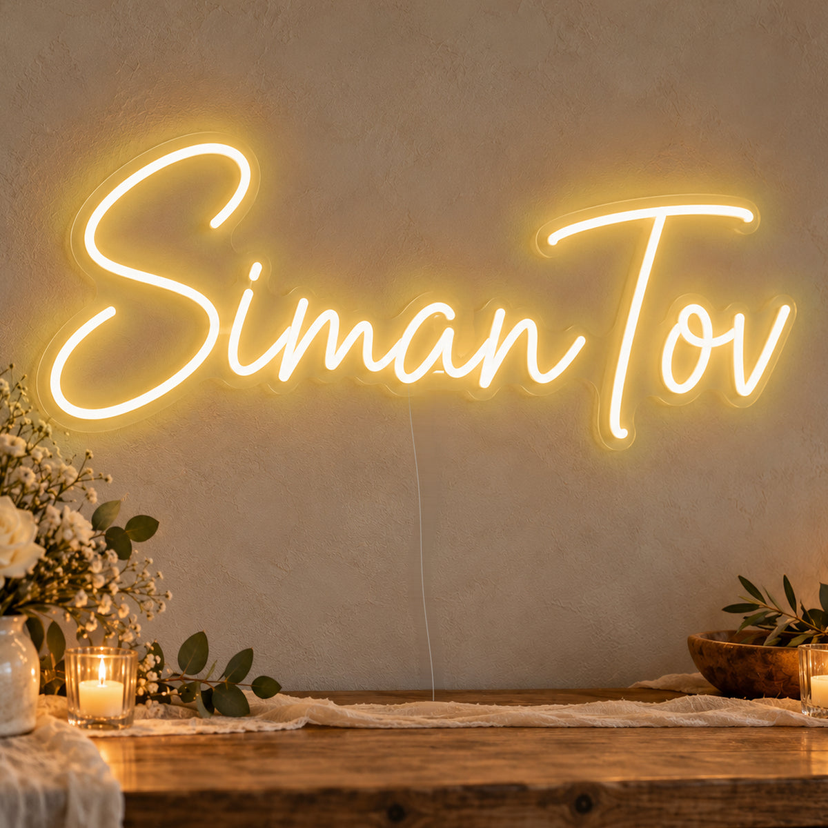 Siman Tov Neon Sign in gold LED neon on clear acrylic, angled view