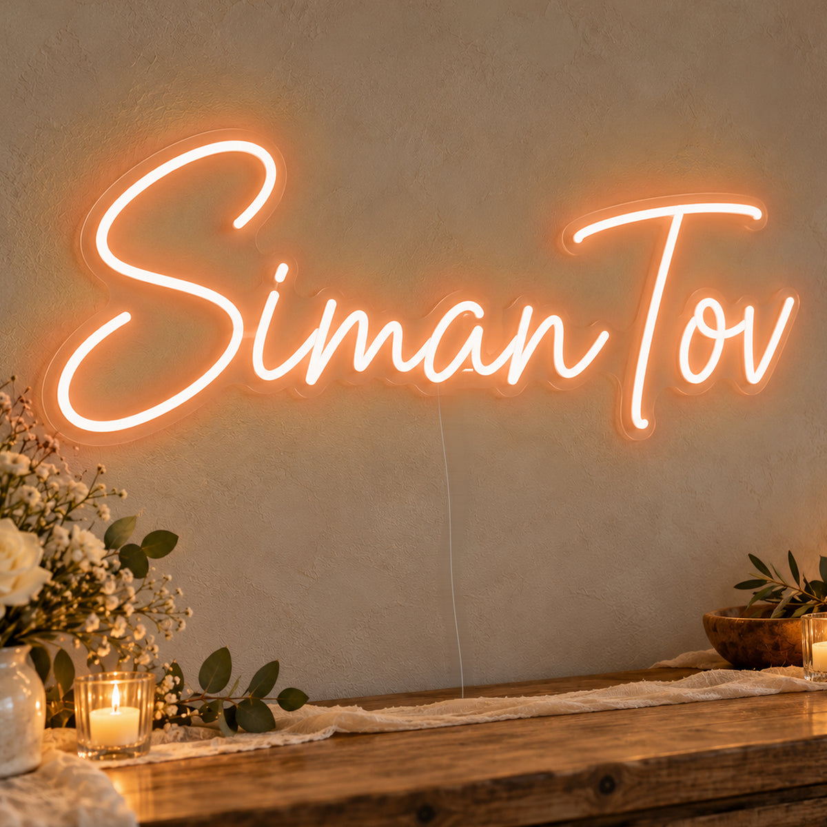 Siman Tov Neon Sign in orange LED neon on clear acrylic, angled view