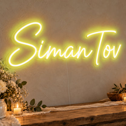 Siman Tov Neon Sign in yellow LED neon on clear acrylic, angled view