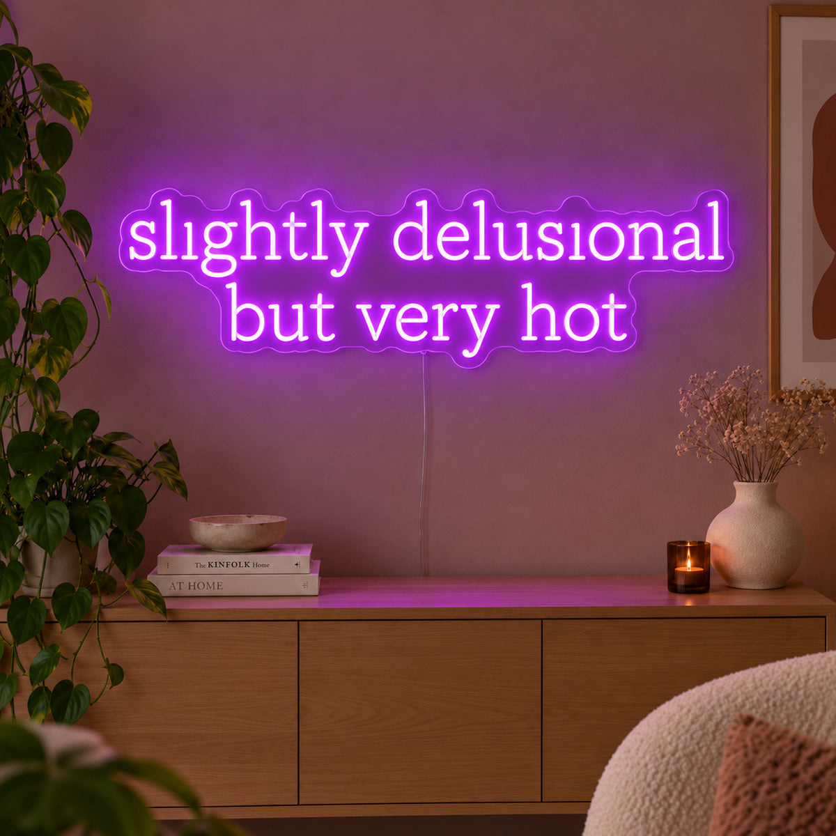 Slightly Delusional But Very Hot Neon Sign with purple lighting, displayed above a wooden sideboard.