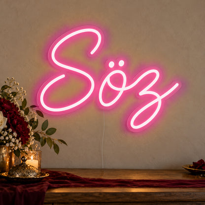 Söz Neon Sign in rose red LED neon on clear acrylic, angled view
